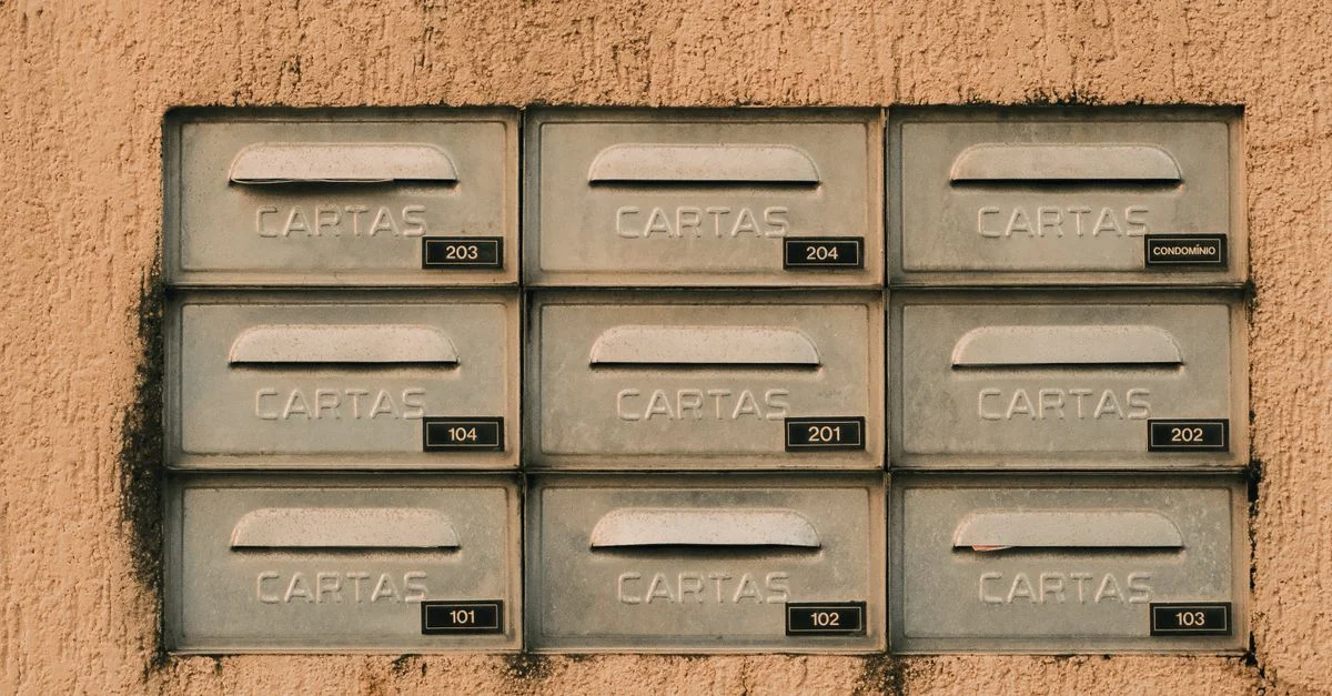Boîtes aux lettres rustiques en métal portant l'inscription « CARTAS » sur un mur texturé, Natal, Brésil.