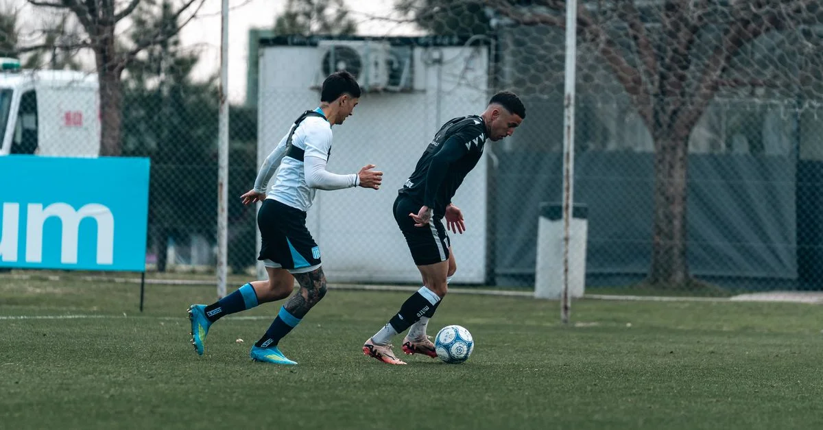 Deux joueurs de football masculins en action sur le terrain, montrant de l'athlétisme et de la compétition.